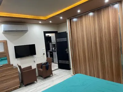 a room with a sliding door and a room with a tv at hotel mirage aqua park in Hurghada