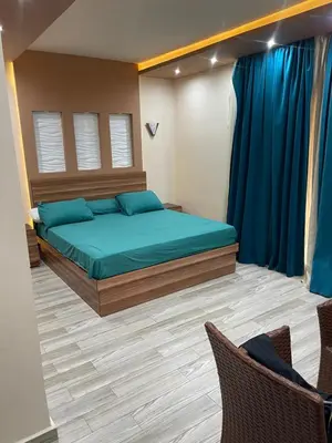 a bedroom with a large bed with blue pillows at hotel mirage aqua park in Hurghada