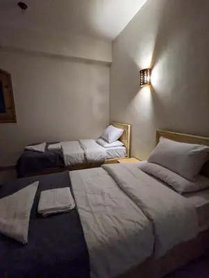 a room with two beds in a room with at Pharaohs Apartments in Luxor