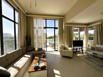 a large living room with a couch and a table at Luminous 4BR Villa, Free Pool & Lagoon Access At Gouna in Hurghada