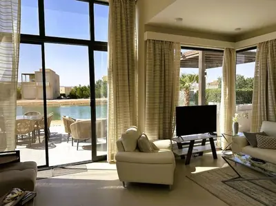 a living room with a large room with a large window at Luminous 4BR Villa, Free Pool & Lagoon Access At Gouna in Hurghada