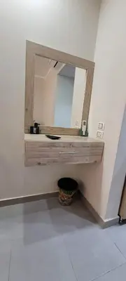a bathroom with a mirror on the wall at Scandic Resort in Hurghada