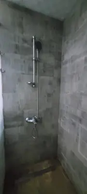 a bathroom with a shower in the corner at Scandic Resort in Hurghada