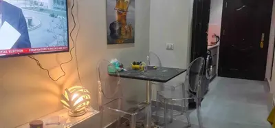 a room with a table and chairs and a screen at Scandic Resort in Hurghada