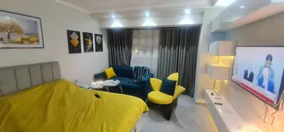 a living room with a yellow bed and a couch at Scandic Resort in Hurghada