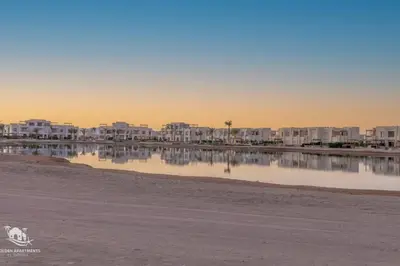 a body of water with buildings in the background at Charming 2-Lvl 3BR Lagoon Home in Shedwan El Gouna, Pool Access in Hurghada