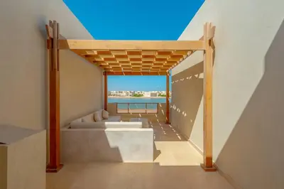 a house with a view of the ocean from a balcony at Charming 2-Lvl 3BR Lagoon Home in Shedwan El Gouna, Pool Access in Hurghada