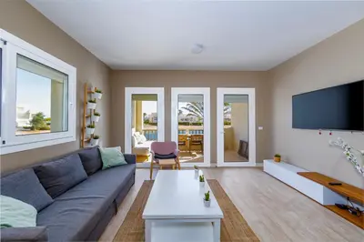 a living room with a couch and a tv at Beautiful apartment with roof terrace in Joubal in Hurghada
