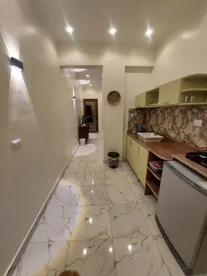a kitchen with a tile floor and a counter at Carter Guesthouse Luxor 2 in ‘Ezbet Abu Ḥabashi