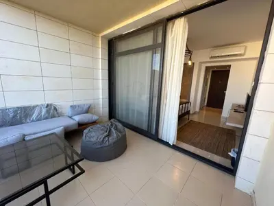 a living room with a couch and a large window at Studio El Gouna G Cribs Hotel in Hurghada