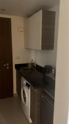 a kitchen with a sink and a washing machine at Studio El Gouna G Cribs Hotel in Hurghada
