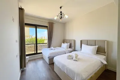a hotel room with two beds and a window at Cordial 2 BDR w Pool Access Cyan El Gouna in Hurghada
