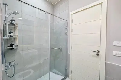 a shower with a glass door in a bathroom at Cordial 2 BDR w Pool Access Cyan El Gouna in Hurghada