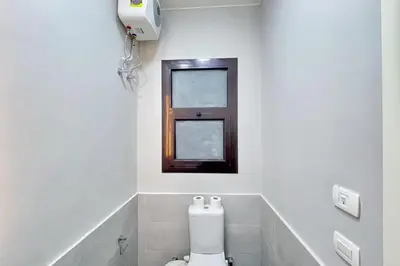 a bathroom with a toilet and a window at Cordial 2 BDR w Pool Access Cyan El Gouna in Hurghada