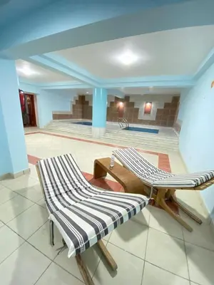 a living room with two chairs and a table at Esplanada hotel Apartments in Hurghada