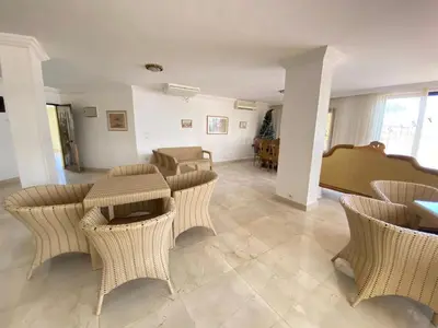 a living room with wicker chairs and a table at Esplanada hotel Apartments in Hurghada