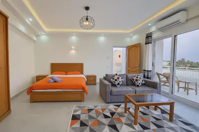 a bedroom with a bed and a couch at LUXOR DREAM - Panoramic Villa in Luxor