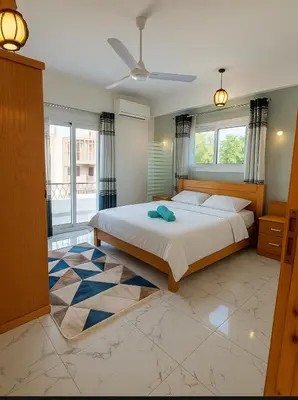 a bedroom with a bed and a large window at LUXOR DREAM - Panoramic Villa in Luxor