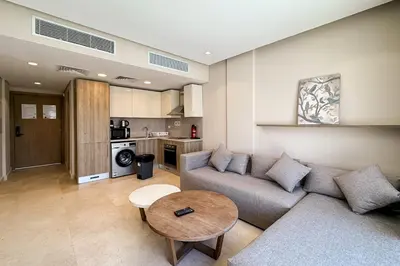 a living room with a couch and a table at Stellar 1BDR Mangroovy Free Pool & Beach Access in Hurghada