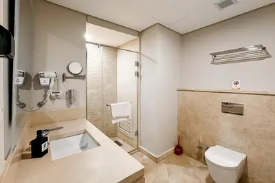 a bathroom with a toilet and a shower at Stellar 1BDR Mangroovy Free Pool & Beach Access in Hurghada