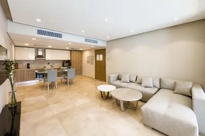 a living room with a couch and a table at Soothing & Stilly 2BDR Mangroovy Pool & Beach Access in Hurghada