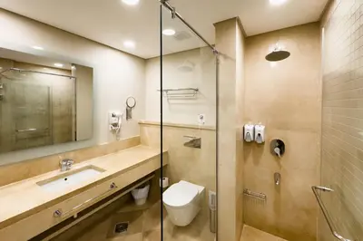 a bathroom with a toilet and a sink and a shower at Soothing & Stilly 2BDR Mangroovy Pool & Beach Access in Hurghada
