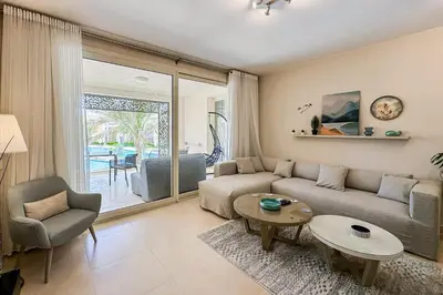 a living room with a couch and a table at Summer Breeze 2 BDR Pool Sea View Mangroovy in Hurghada