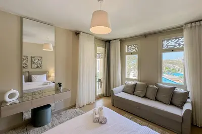 a living room with a couch and a bed and a mirror at Summer Breeze 2 BDR Pool Sea View Mangroovy in Hurghada