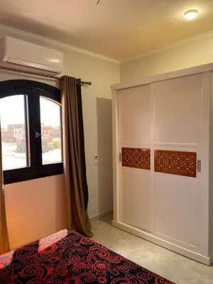 a bedroom with a bed and a large closet at Villa Muhammad in Quseir