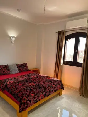 a bedroom with a bed and a window at Villa Muhammad in Quseir
