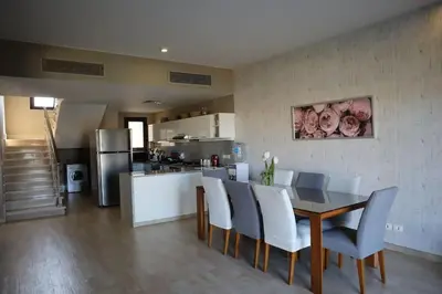 a kitchen and dining room with a table and chairs at Water front luxury 3BD villa in Hurghada