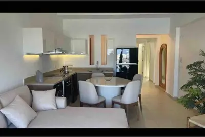 a kitchen and living room with a couch and a table at 3 Bedrooms with roof in Makadi in Hurghada