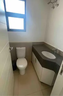 a bathroom with a toilet and a sink and a window at 3 Bedrooms with roof in Makadi in Hurghada