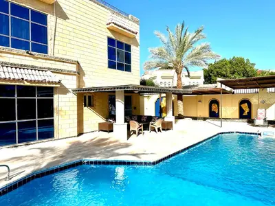 a swimming pool in front of a house at Private villa in Hurghada in Hurghada