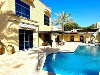 a swimming pool in front of a house at Private villa in Hurghada in Hurghada