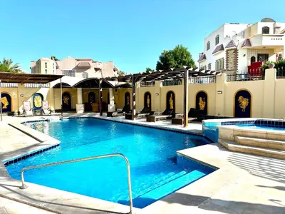 a large swimming pool in front of a building at Private villa in Hurghada in Hurghada