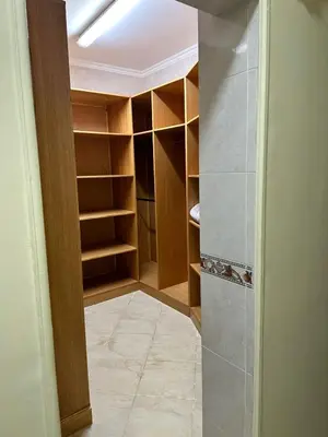 a walk in closet with wooden shelves and a hallway at Private villa in Hurghada in Hurghada