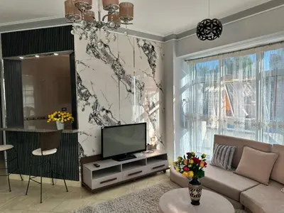 a living room with a couch and a television at Private villa in Hurghada in Hurghada