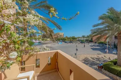a view of the beach from the balcony of a resort at Luxury apartment on the Marina in Hurghada