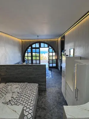 a bedroom with a bed and a kitchen with a refrigerator at Mastaba Village Hurgada House in Hurghada