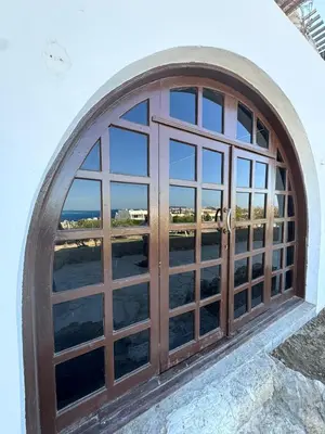 an arched window with a view of the ocean at Mastaba Village Hurgada House in Hurghada