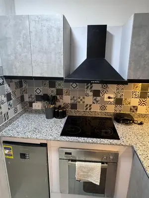 a kitchen with a stove and a counter top at Mastaba Village Hurgada House in Hurghada