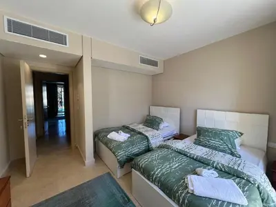 a bedroom with two beds with towels on them at M Residence with Pool View & Beach Access - El Gouna, Hurghada in Hurghada