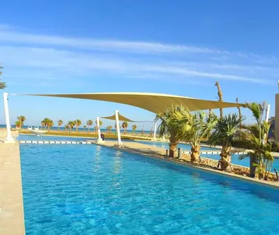 a resort swimming pool with a canopy over it at M Residence with Pool View & Beach Access - El Gouna, Hurghada in Hurghada