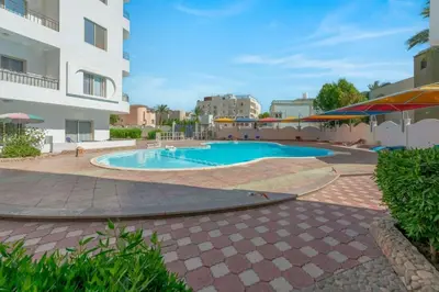a swimming pool in a courtyard of a building at Luxury apartment on the pool in Hurghada