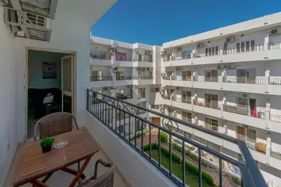 a balcony of a hotel with a table and chairs at Luxury apartment on the pool in Hurghada