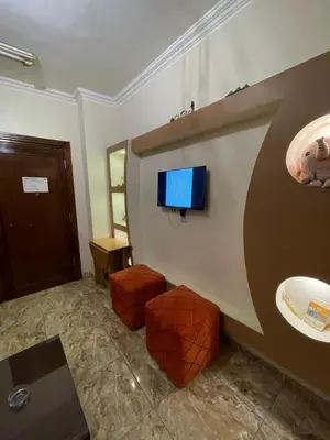 a bathroom with a sink and a tv on the wall at Luxe Nest Luxor Serviced Apartments 101 in Luxor