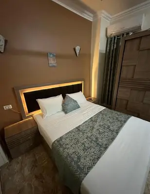 a bedroom with a large bed in a room at Luxe Nest Luxor Serviced Apartments 101 in Luxor