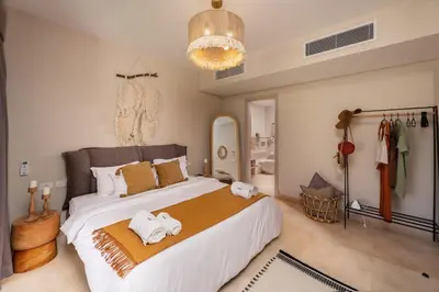 a bedroom with a large bed with towels on it at Secluded & Bespoke 1 BDR Apt with Pool View & Beach access in Hurghada