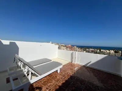 a room with a bed on a balcony with a view at Kite and Dive Home in Hurghada